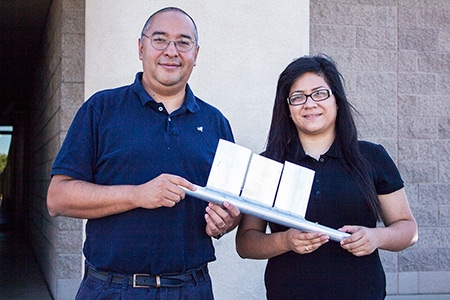 Professor Gerardo Diaz and student Azucena Robles show one piece of a mini channel panel.