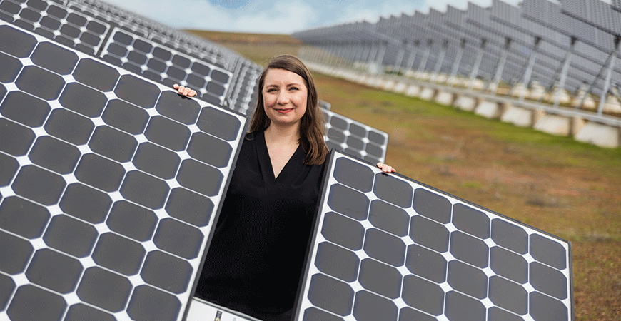 Engineering Professor Marie-Odile Fortier stands among the solar array that helps power the campus.
