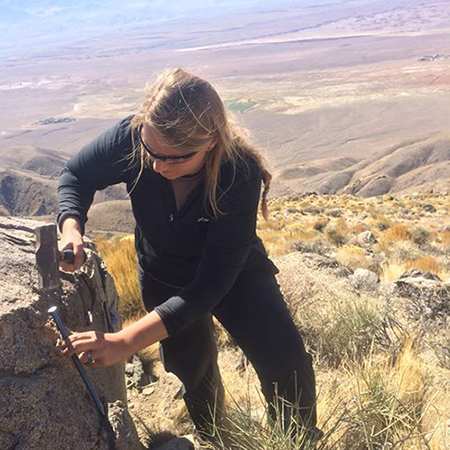 Morgan Barnes collecting rock samples in the White Mountains (California).
